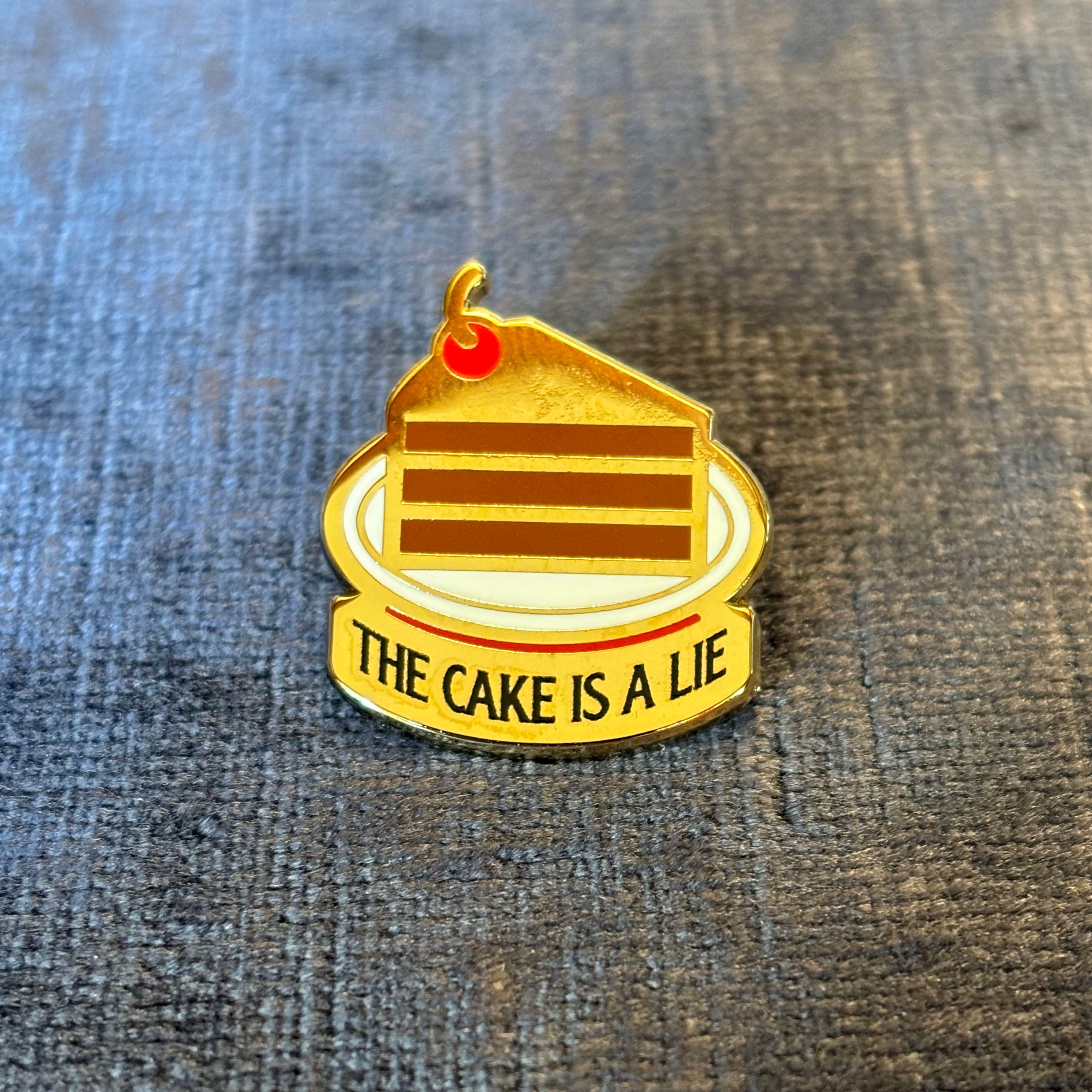 The Cake is a Lie Enamel Pin – A Portal-Inspired Tribute to Gaming Lore