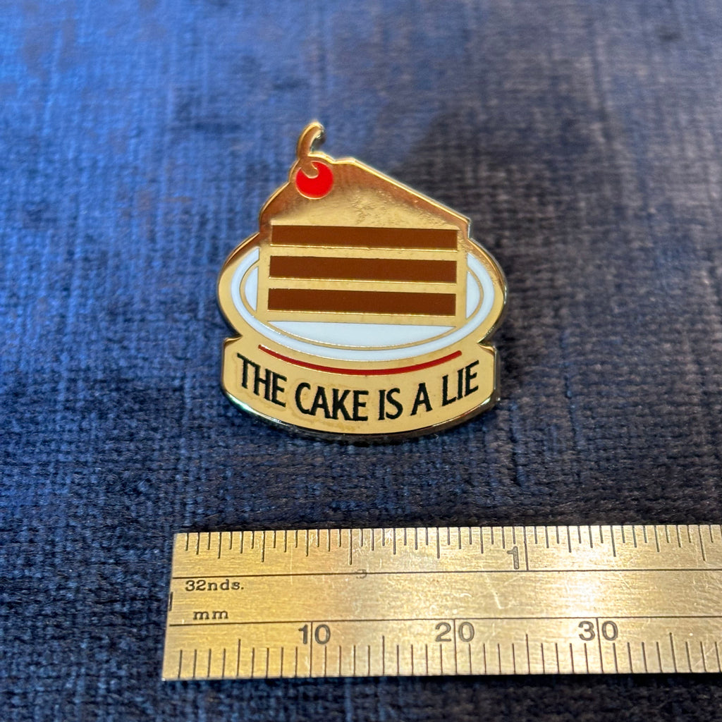 The Cake is a Lie Enamel Pin – A Portal-Inspired Tribute to Gaming Lore