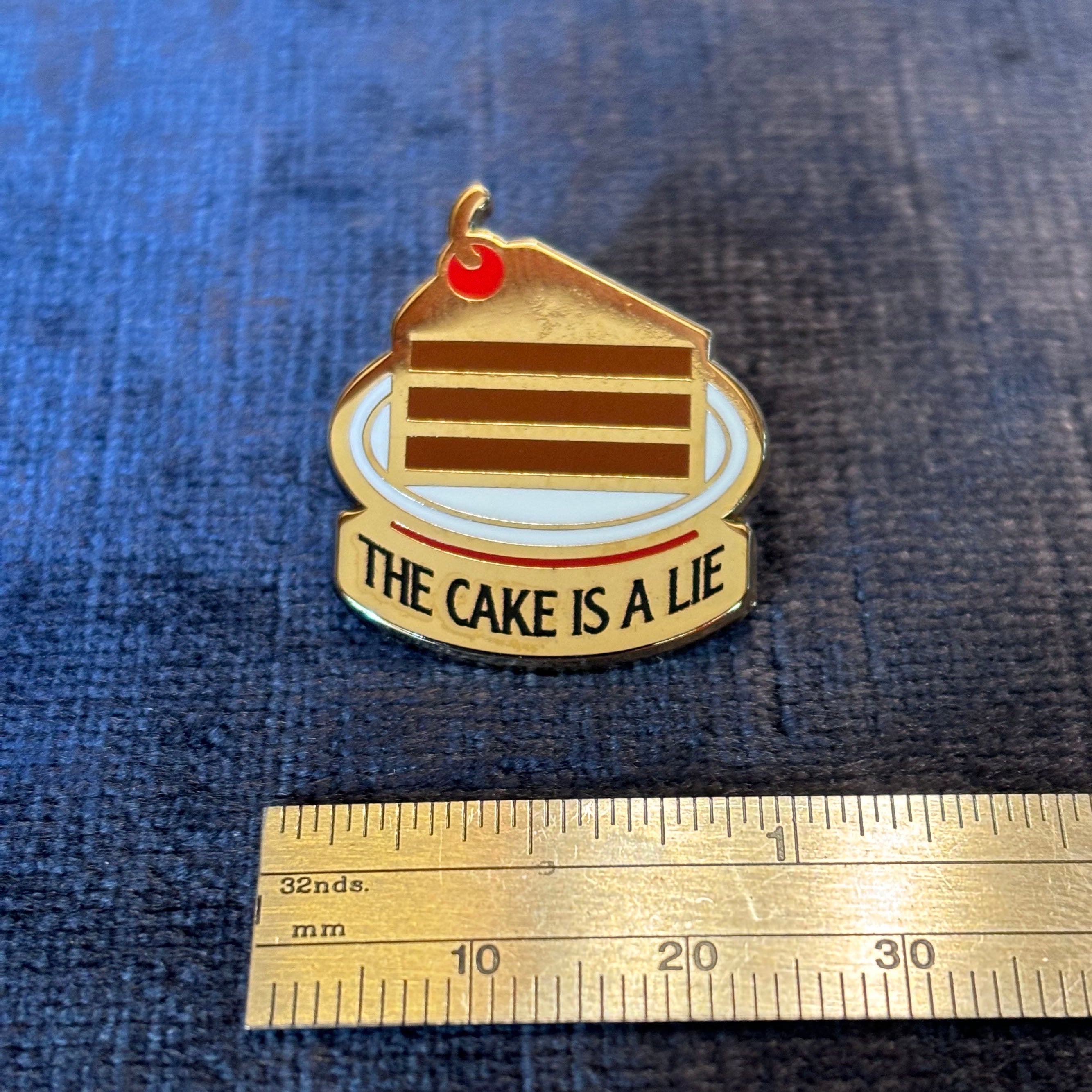 The Cake is a Lie Enamel Pin – A Portal-Inspired Tribute to Gaming Lore